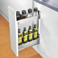 A stainless steel pullout cabinet organizer containing bottles, designed to fit inside a kitchen cabinet.
