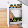 A stainless steel pullout cabinet organizer containing bottles, designed to fit inside a kitchen cabinet.