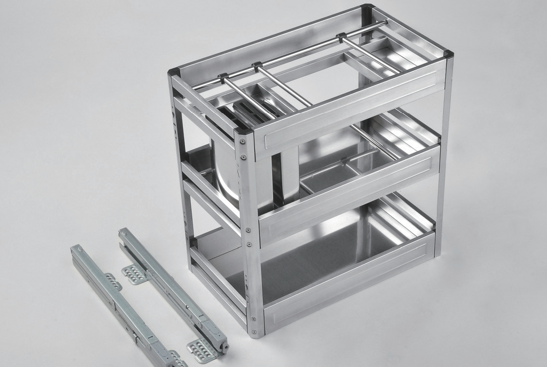 A stainless steel multifunctional pullout seasoning drawer installed in a kitchen cabinet, containing spices, condiments, and kitchen utensils.