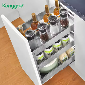 Open kitchen drawer with various items including bottles and containers on a wooden floor.