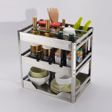 A stainless steel multifunctional cabinet drawer basket with multiple compartments, containing kitchen utensils and containers.