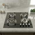 Black gas stove with four burners on a kitchen counter