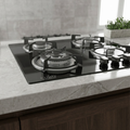 Black gas stove on a marble countertop with a modern kitchen setting.