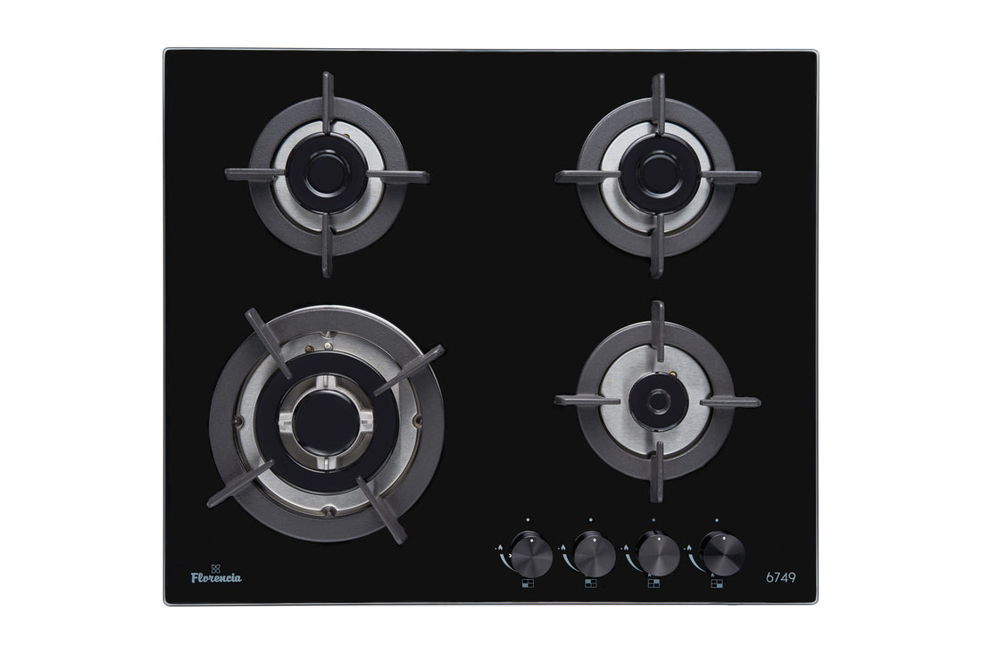 Black gas stove with four burners on a white background