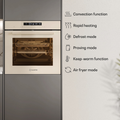 A built-in oven appliance shown in a kitchen setting, with a vertical panel of text on the right listing features such as convection, rapid heating, defrost, proving, keep-warm, and air fryer modes.
