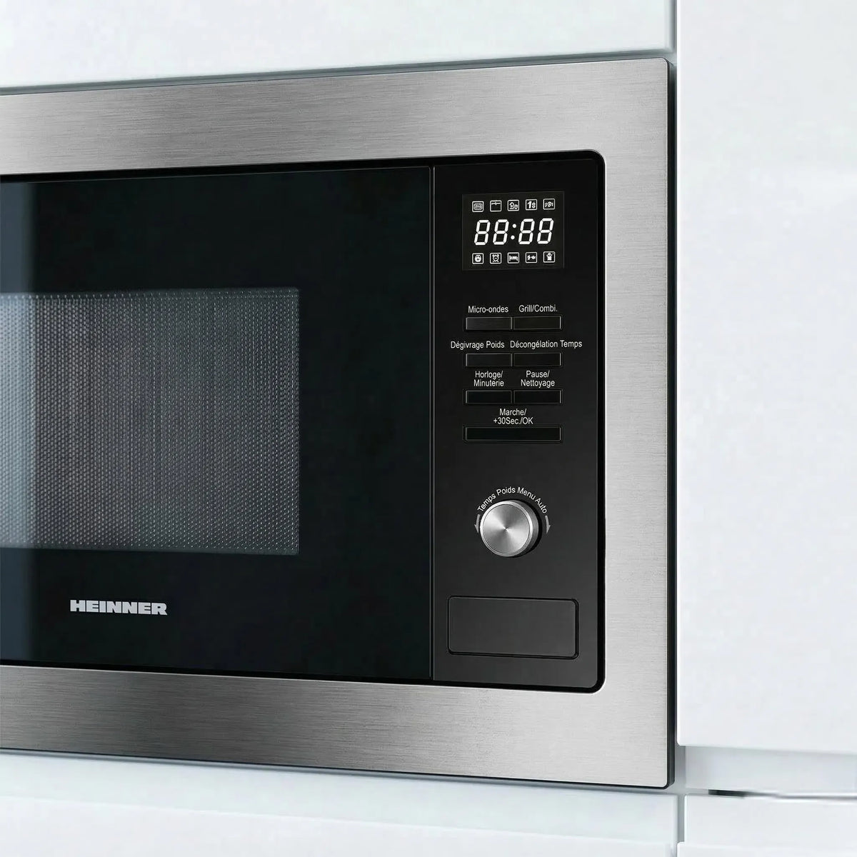 A close-up of a stainless steel and black HENNIGER microwave oven showing the control panel, digital display, and dial.