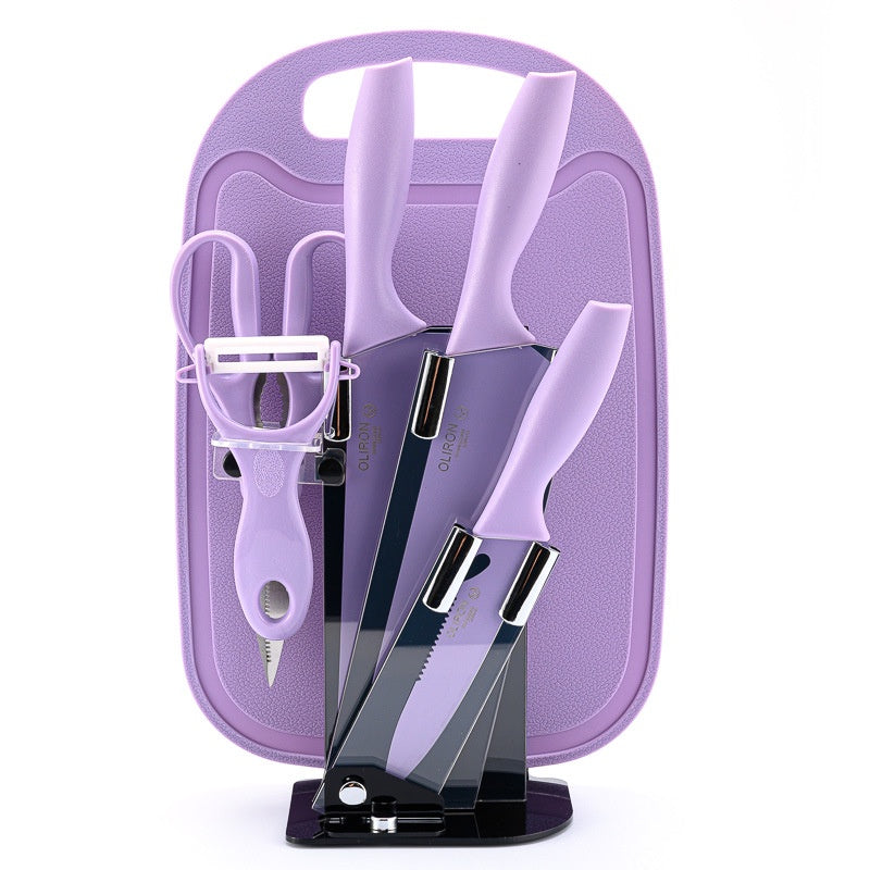 Set of knives and a peeler in a purple case on a white background