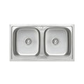 Stainless steel double basin kitchen sink on a white background