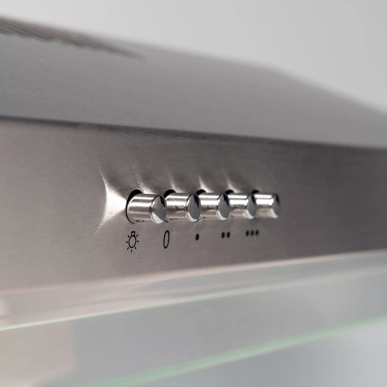 Control panel of a modern kitchen hood with light and volume controls.