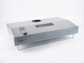 Stainless steel range hood with remote control on a white background