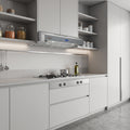 A modern kitchen interior with white cabinetry, a stainless steel range hood, a gas stovetop, open shelves with jars and containers, and a gray floor.