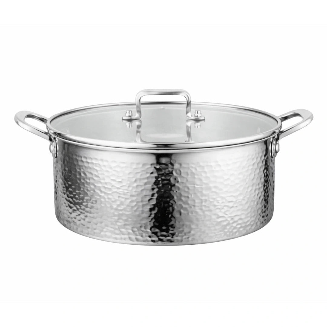 A hammered stainless steel stockpot with a matching glass lid, featuring side handles and a top handle, shown against a plain white background.