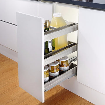 A stainless steel multi-purpose kitchen drawer basket organizer with multiple shelves, installed in a white kitchen cabinet.